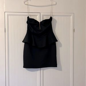 Black strapless mini dress with hip flare and zipper accent by Charolette Russe
